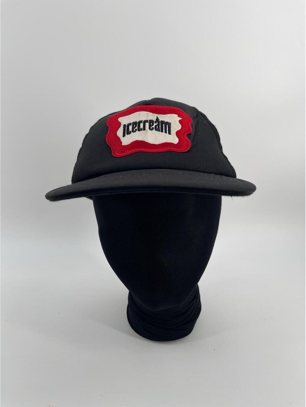 Icecream Inset Trucker Hat in black mesh with‎ a red and white logo patch.
